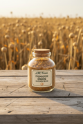 Glass spice jar of Farmhouse Onion Seasoning Blend on a rustic wooden farm table