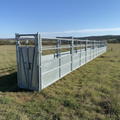 Long narrow galvanized steel chute set up on a grassy field